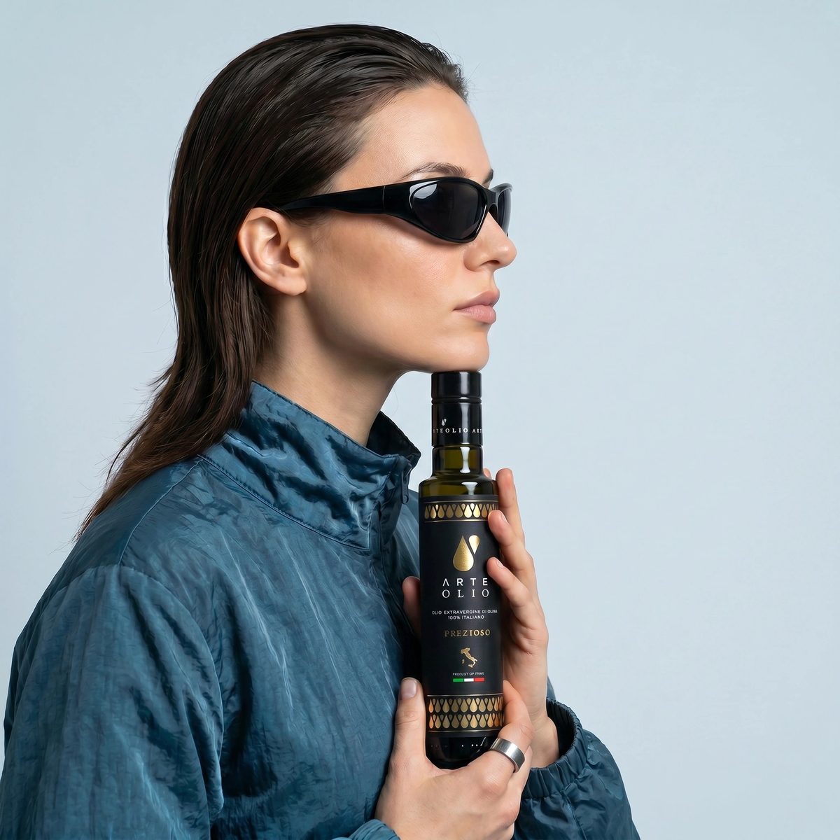 ArteOlio Prezioso extra virgin olive oil 500ml — Italian model holding bottle in editorial style