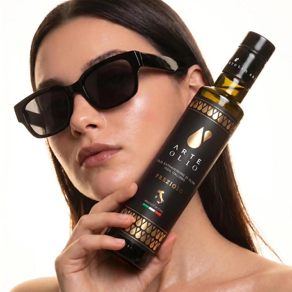 ArteOlio Prezioso extra virgin olive oil 500ml held by model in luxury editorial style — 100% Italian